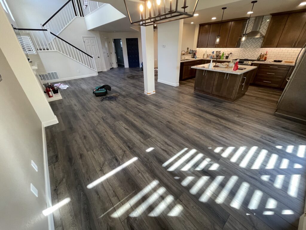 Luxury vinyl plank flooring in an open kitchen and living room